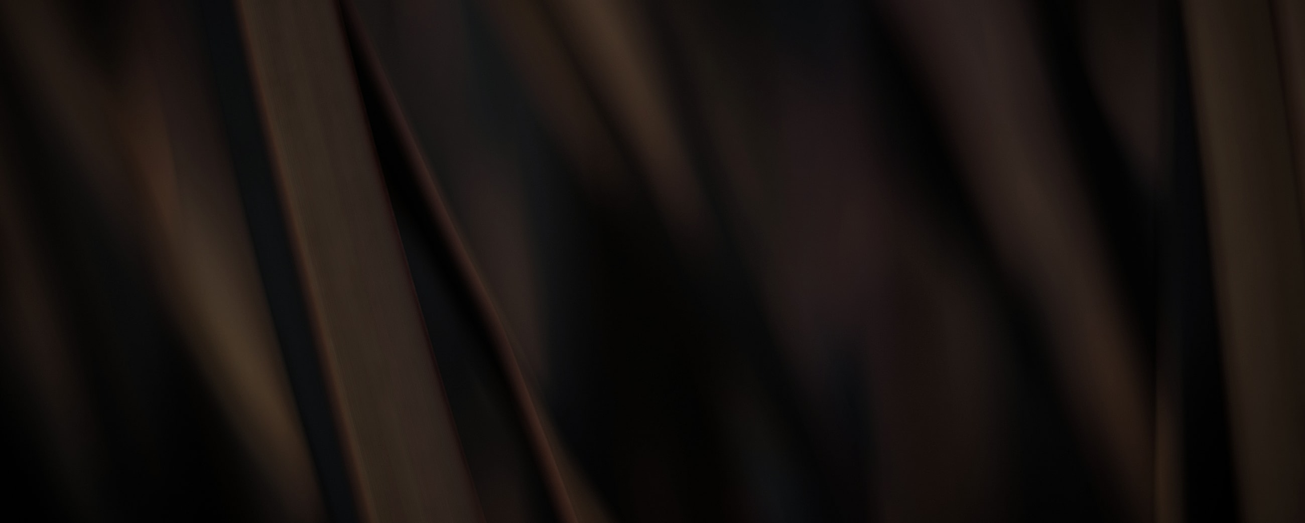 Abstract dark patterned texture with gentle waves.