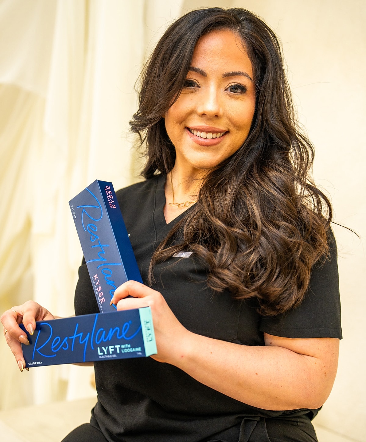 Woman holding Restylane products in clinic.