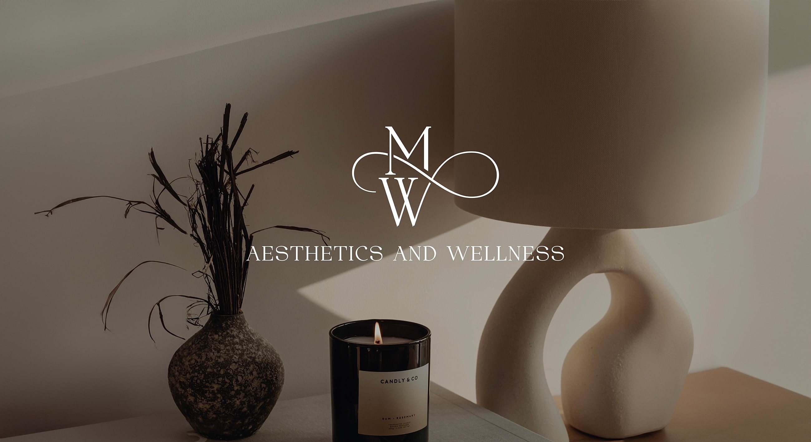 Elegant decor featuring candle, vase, and lamp.